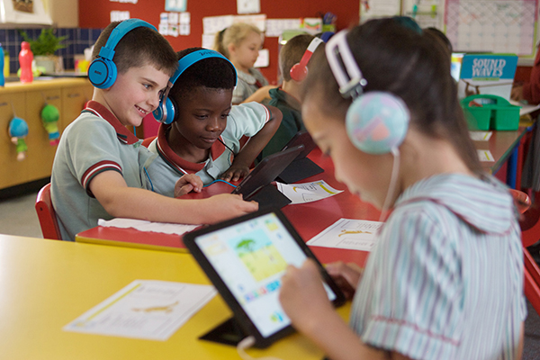 students with headphones on their IPads
